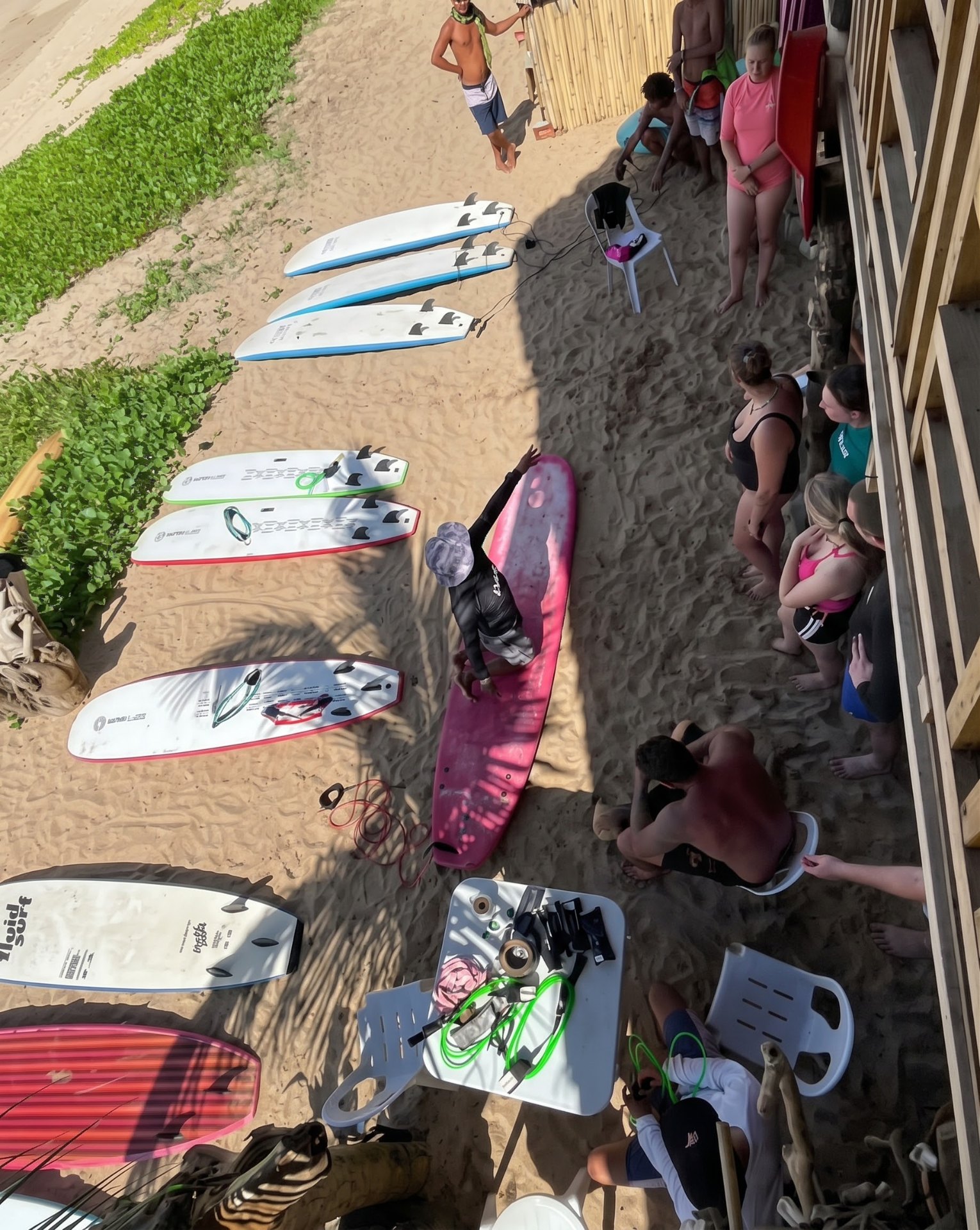 Overhead view of the surfboard quiver racked on the sand at Duli Beach